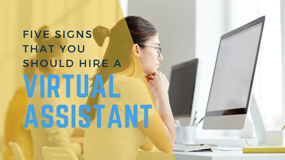 "Five Signs That You Should Hire a Virtual Assistant" blog heading and employees in a row working on computers
