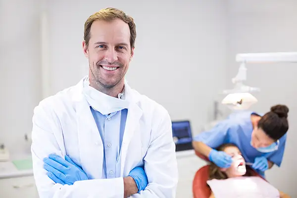 Smiling Dentist Enjoying The Benefits of Dental Virtual Assistants